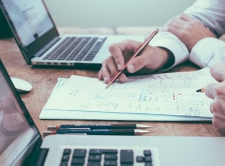 man writing on a notebook