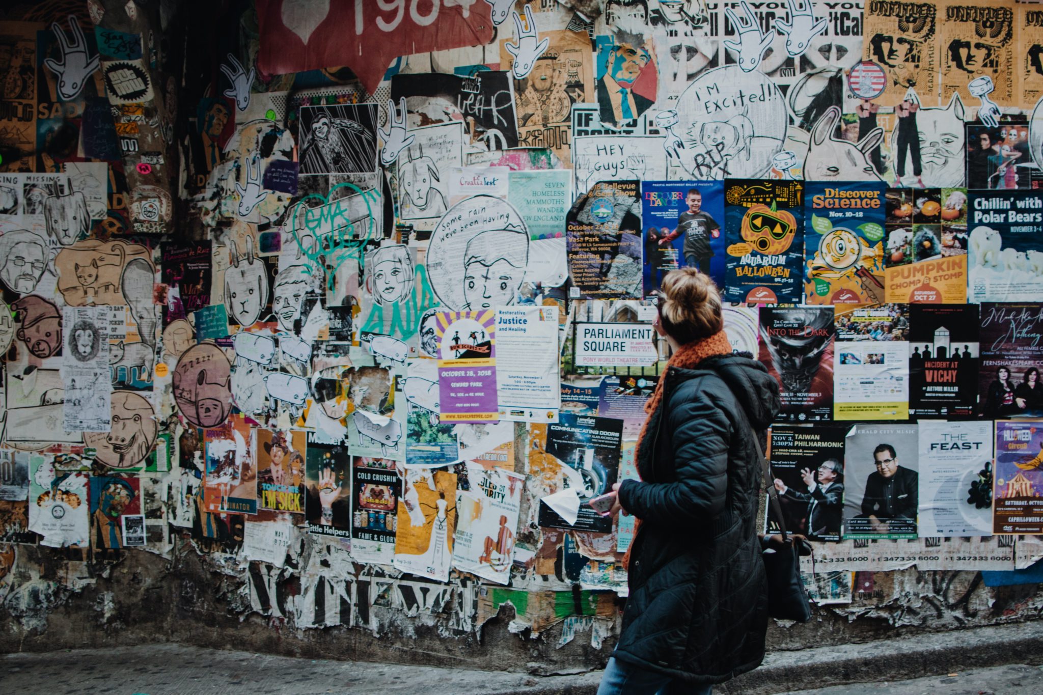 Woman Standing in Front of Ads on Street