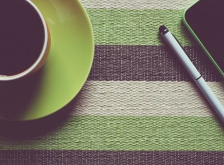 cup of coffee, pen and smartphone